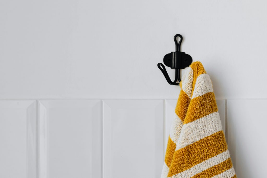 Orange towel hang on black towel holder